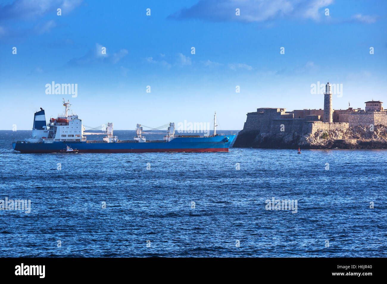 cargo ship and old fortress with lighthouse Stock Photo Alamy
