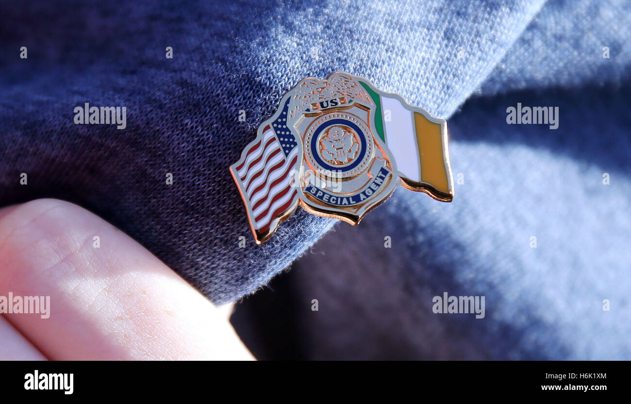 A young woman displays a pin badge given to her by a US Secret Service agent as US Secretary of State John Kerry receives the Tipperary Peace Prize during a ceremony at the Aherlow House Hotel in Tipperary, Ireland. Stock Photo
