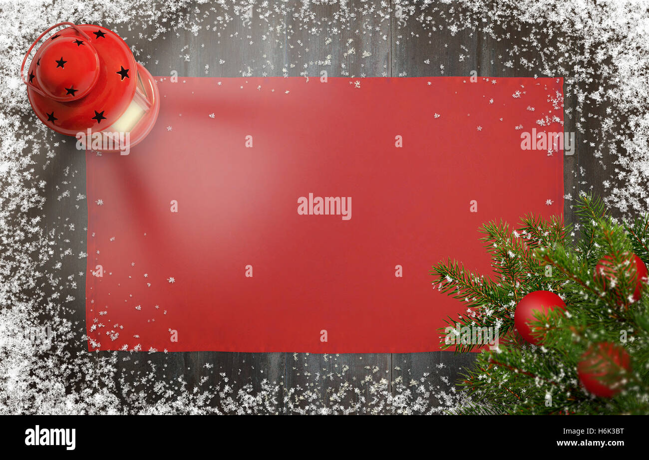 Christmas background with christmas tree, lantern, tablecloth and snowflakes on wooden board. Free space for greeting card text. Stock Photo