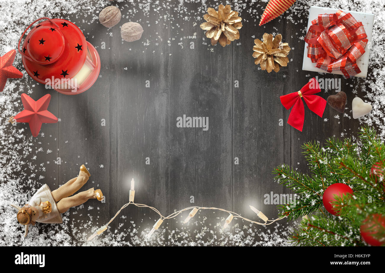 Christmas New Year background image with christmas tree, gift, decorations, lantern and snowflakes on wooden board. Stock Photo