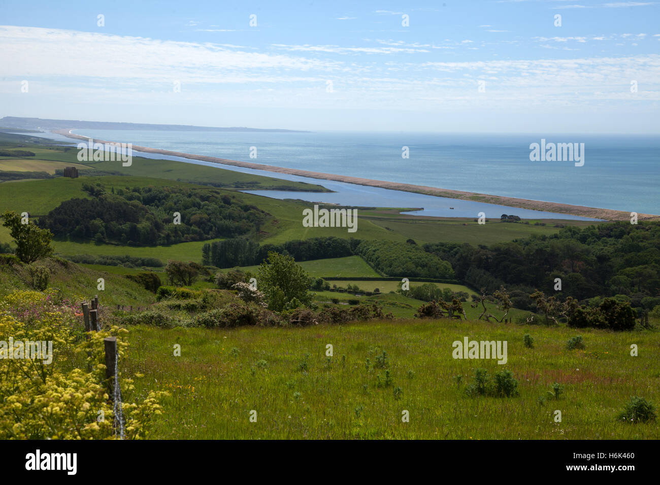 View looking out over Chesil Beach, from the Dorset countryside towards Weymouth. The beach is a World Heritage Site Stock Photo