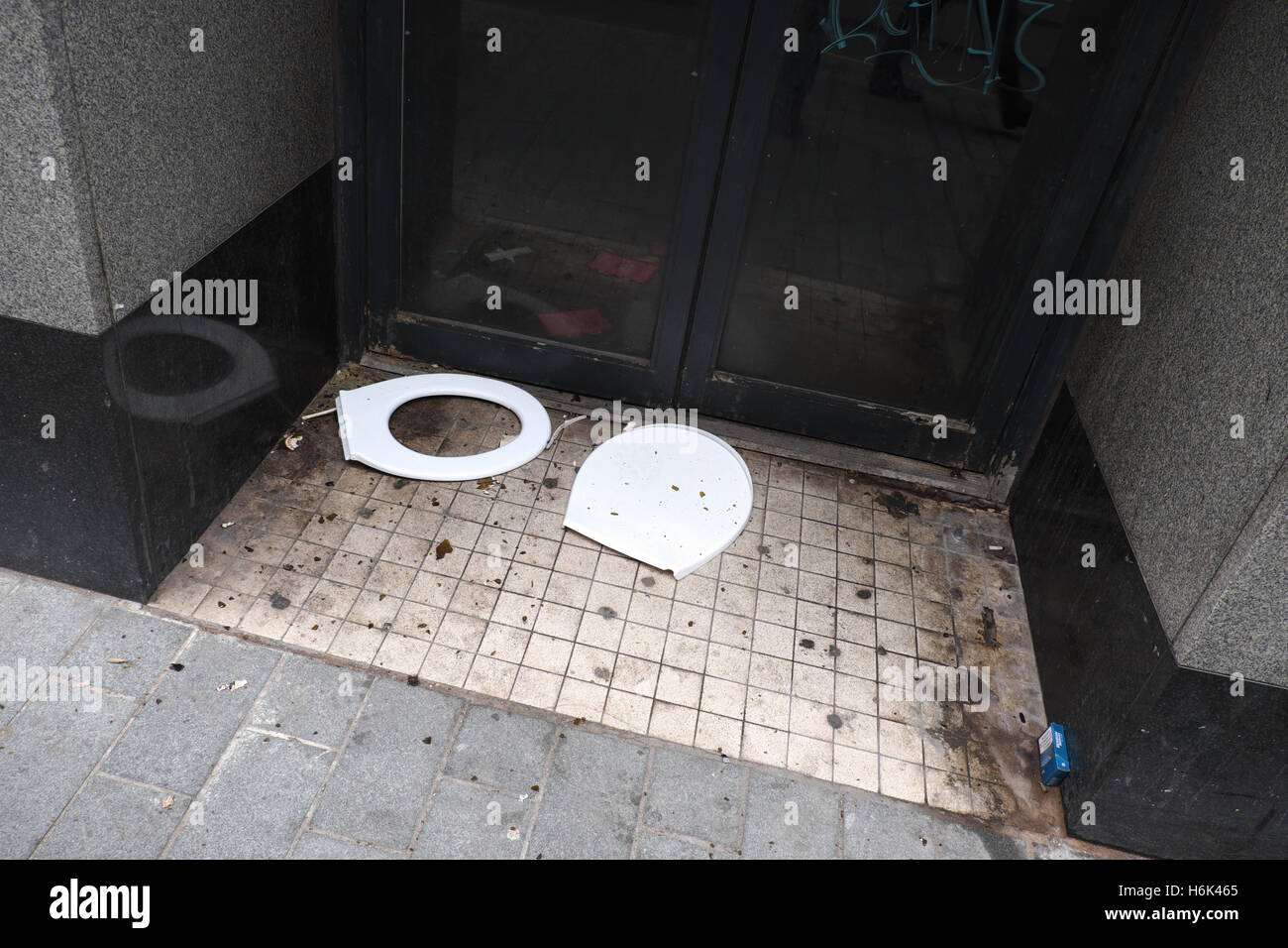 Birmingham city centre a discarded broken toilet seat in a dirty entrance in New Street Birmingham UK Stock Photo