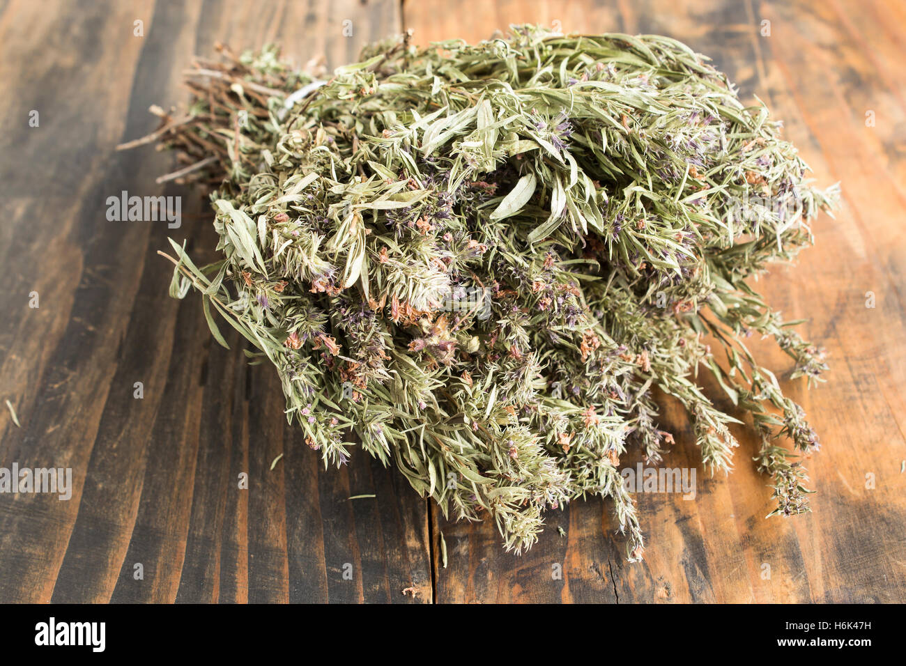 Summer Savory , Satureja Hortensis, on Rustic Wooden Background. Stock Photo