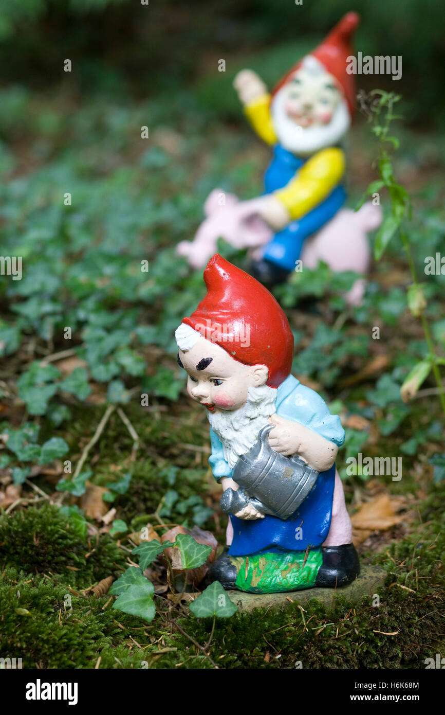 Female gnome watering the garden Stock Photo