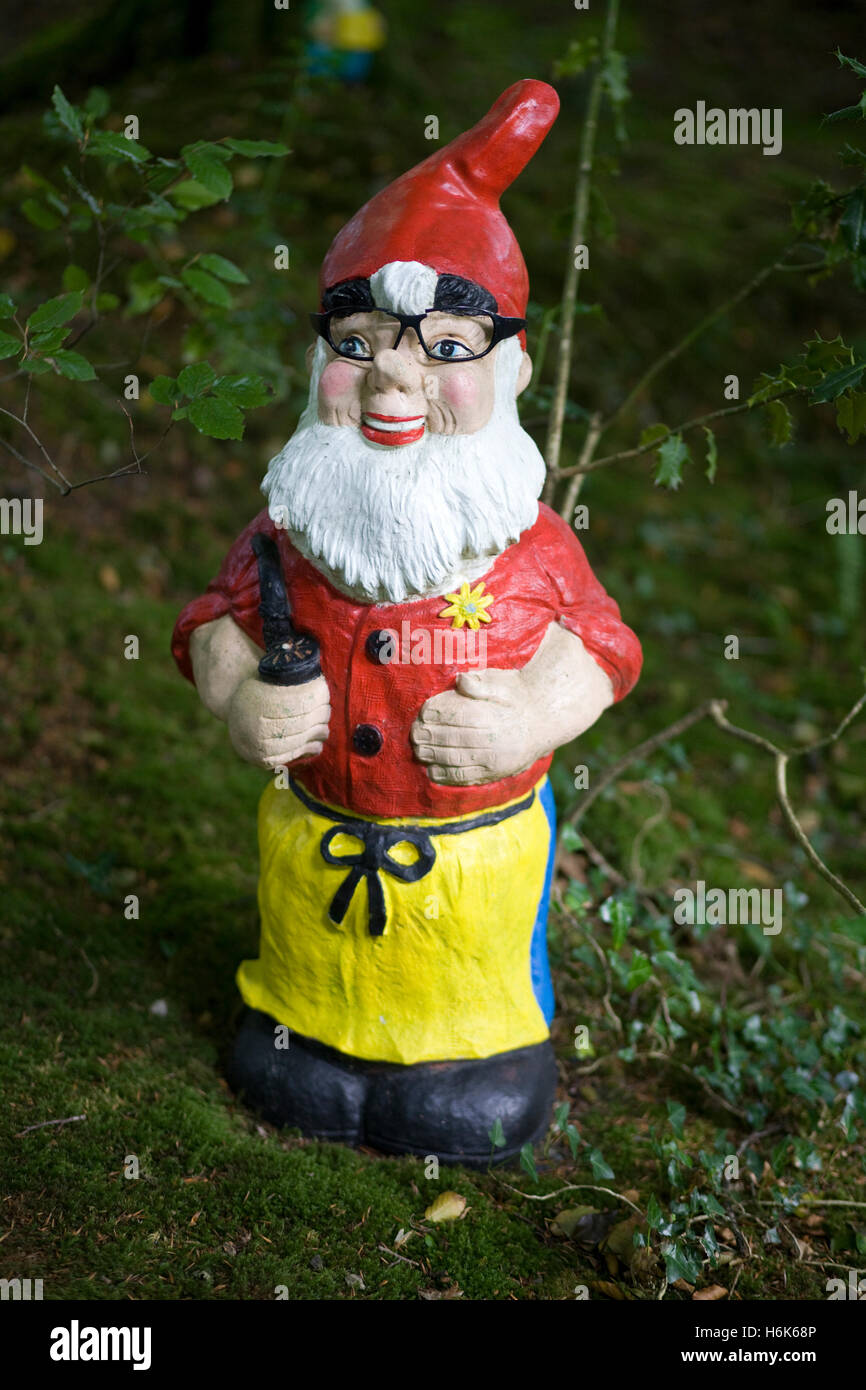 garden gnome in glasses and holding a pipe Stock Photo