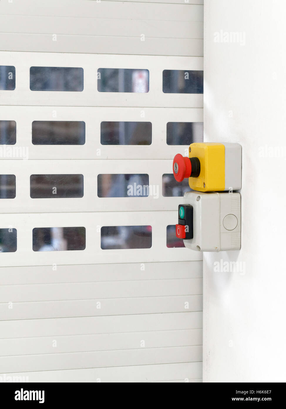 Accordion door, switch and emergency stop button are visible Stock Photo