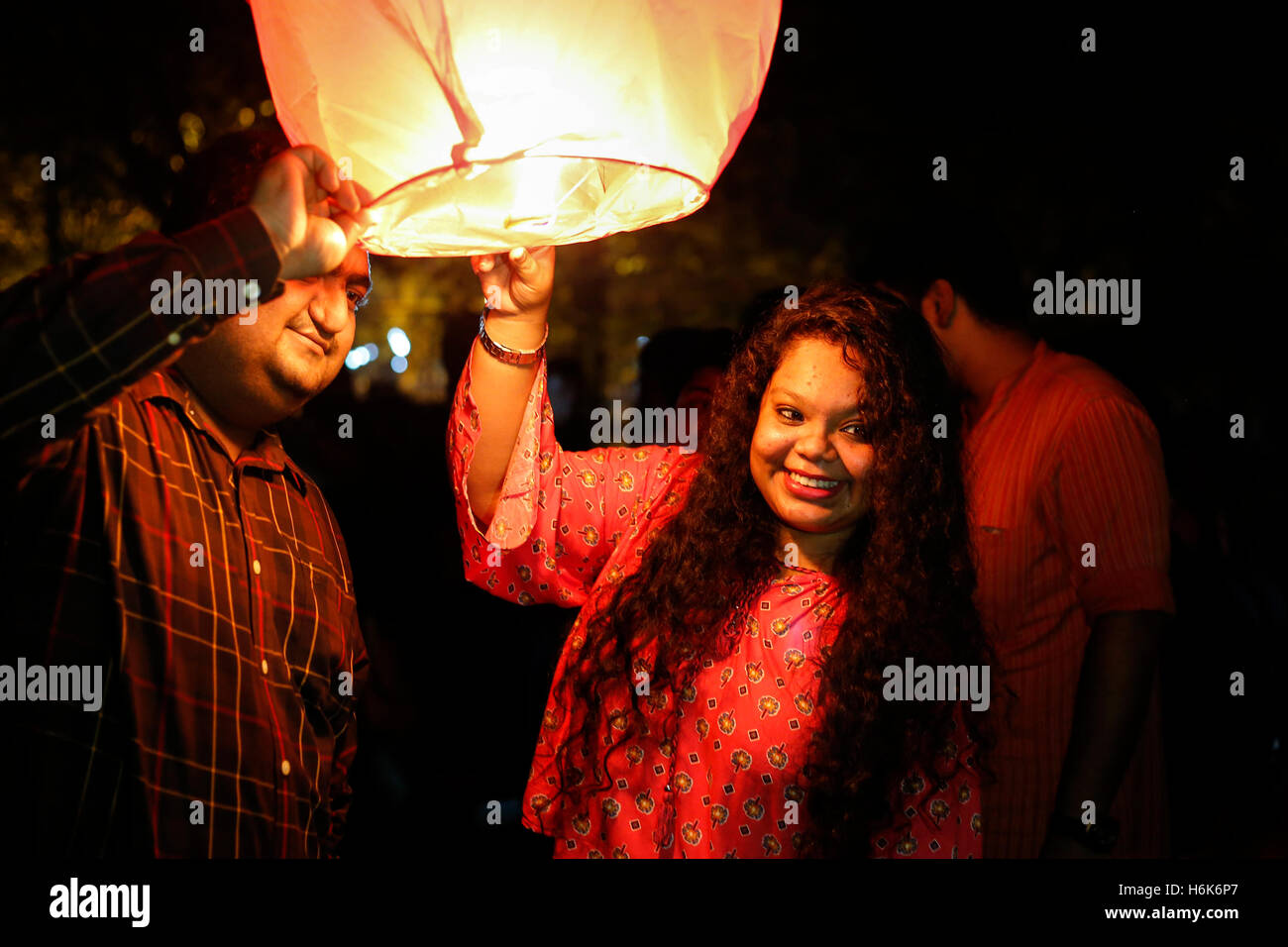 Sky Lantern Lighting by a Pair of Hands Holding the Paper Hot Air Balloon  in a Black Background Stock Image - Image of lamp, fire: 150374387