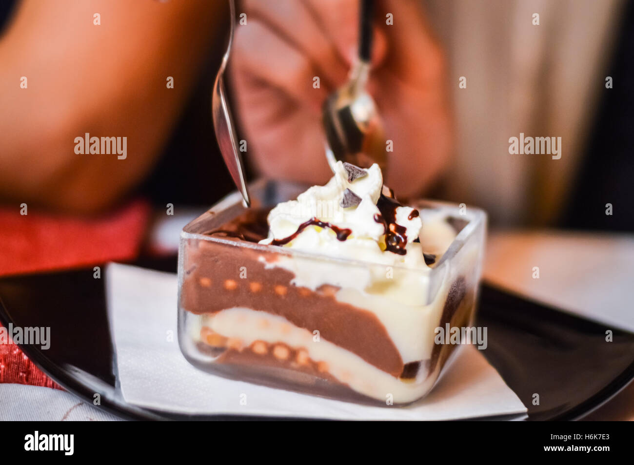 sharing a tiramisu dessert in a square cup with two spoons Stock Photo ...