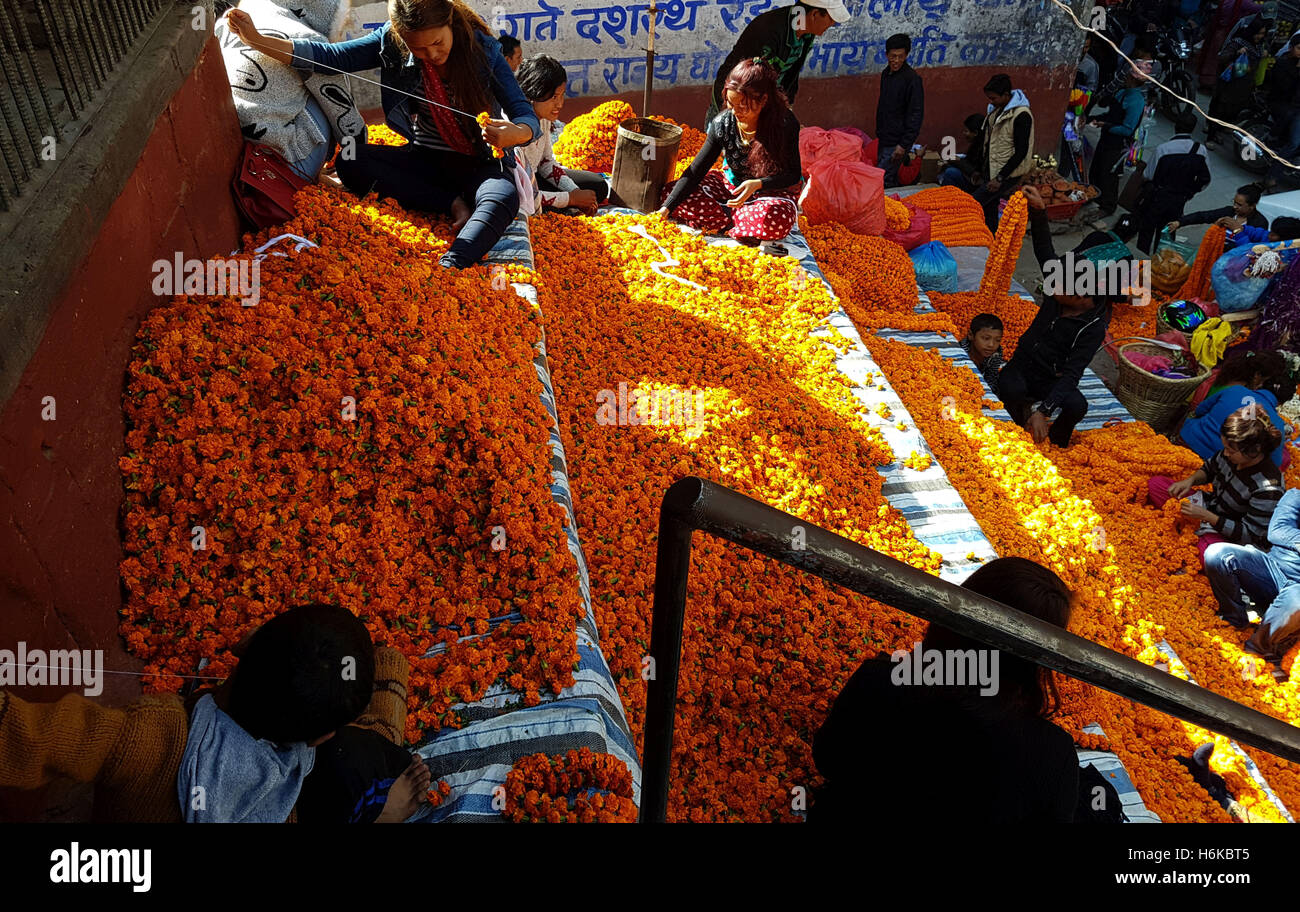 Kathmandu, Nepal. 30th Oct, 2016. Nepali people make garlands used for