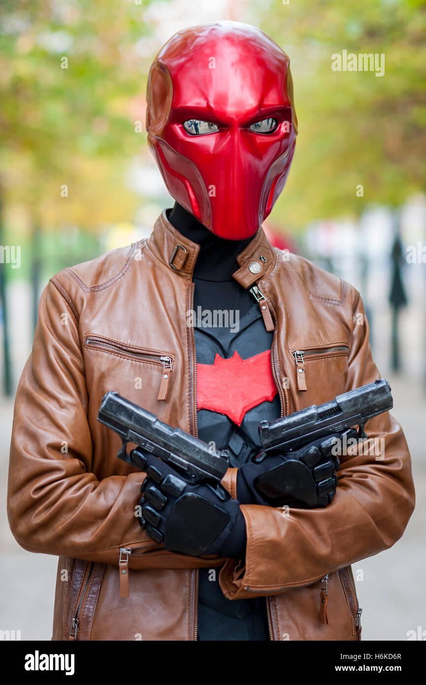 London, UK. 30 October 2016. A man dresses as The Red Hood, a character  from Batman comic books, as cosplay, anime, games and movie fans attend the  popular MCM Comic Con festival