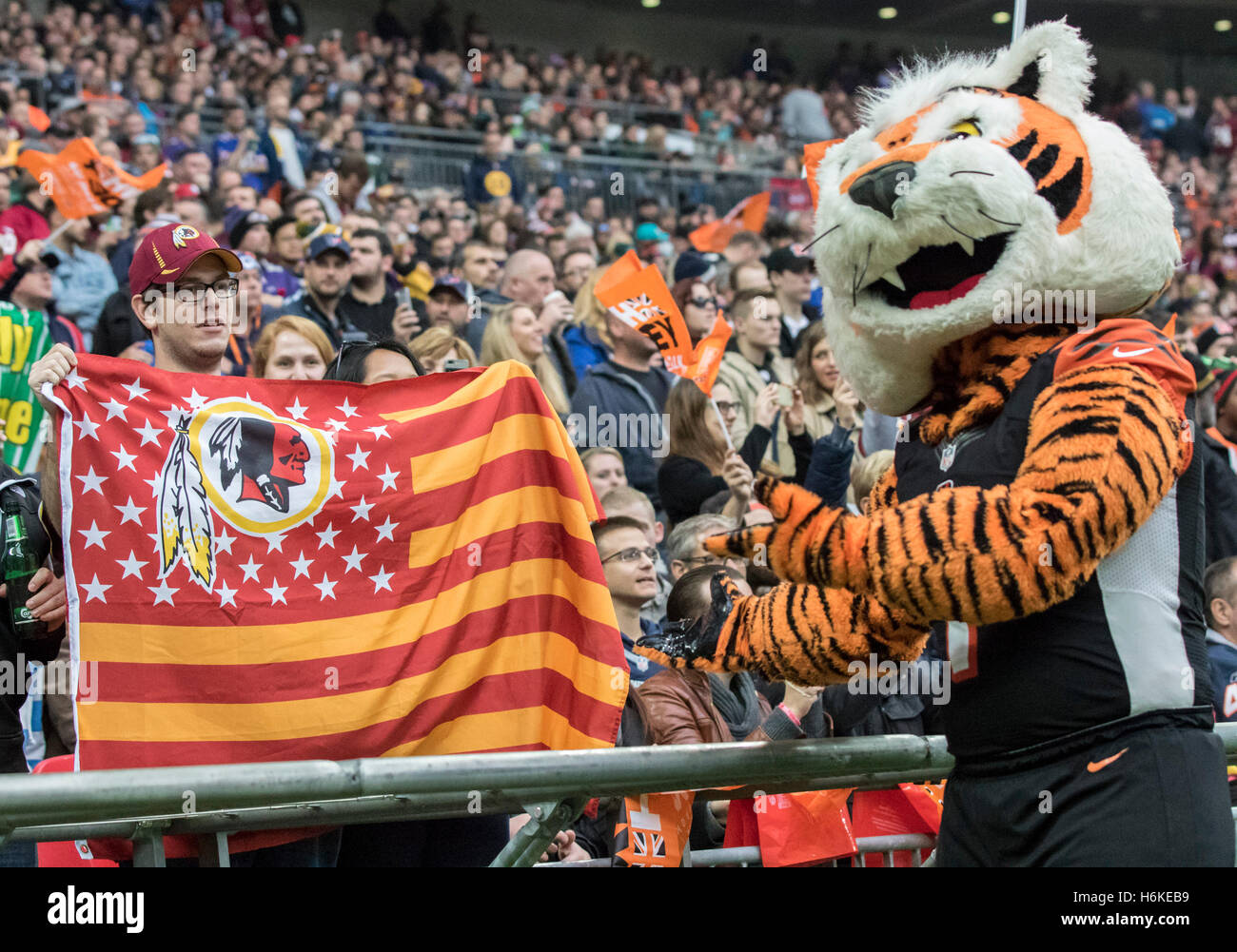 Wembley Stadium, London, UK. 30th Oct, 2016. NFL International Series. Cincinnati Bengals versus Washington Redskins. The Cincinnati mascot 'WHO-DEY' pointing to a Washington Redskins fan in the front row of the stands holding a Redskins flag during the game. © Action Plus Sports/Alamy Live News Stock Photo