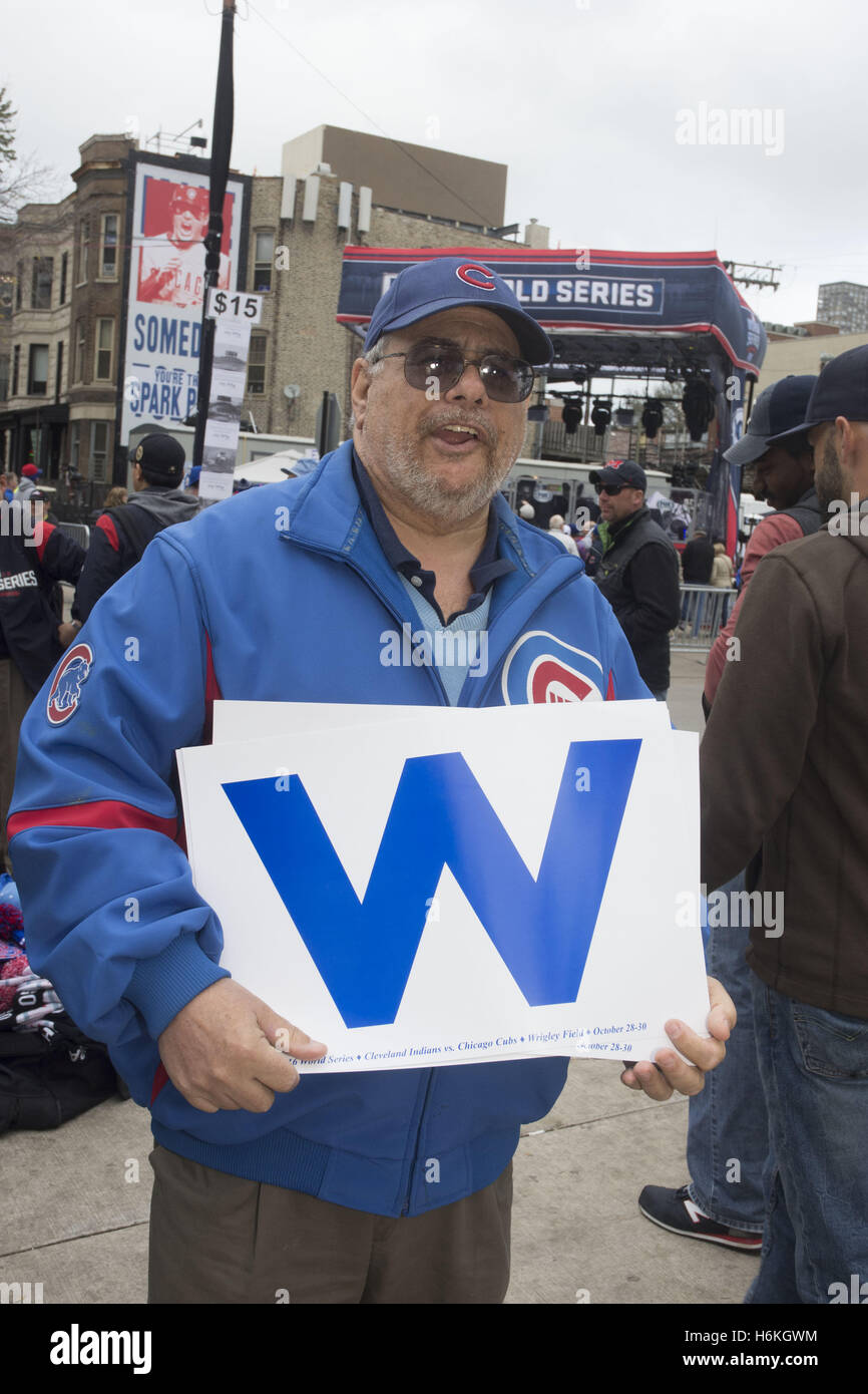 Chicago, IL, USA. 30th Oct, 2016. Cubs fans gather near Wrigley Field on October 30, 2016. The fifth game of the World Series takes place at ''the Friendly Confines.'' on Chicago's North side. Cubs must win in this game to stay in the Series. Game score in the Series to date is Cleveland Indians 3 to Cubs 1. There were some unusual sites around the stadium - a live goat reminding people of the Billy Goat curse, Teddy Roosevelt waling around and Harry Carry, and Ron Santo statues wearing Cubs shirts. Pictured: Ed Landeman, for president of the Booster Club, displaying the W (Credit Imag Stock Photo