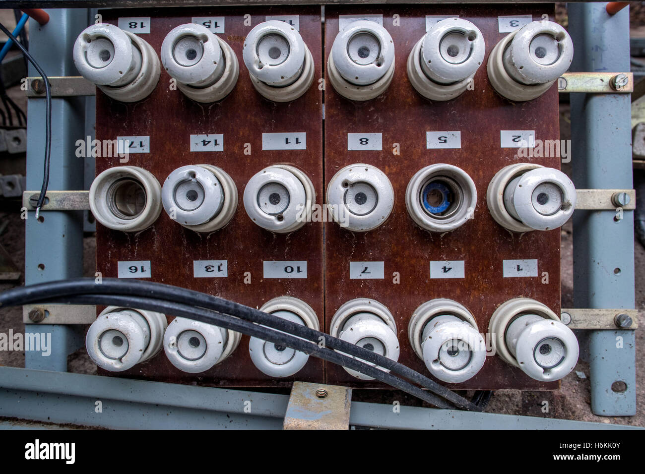 An old fuse panel with ceramic fuses from East Germany seen in the former 'people's swimming pool' in the district of Lankow in Schwerin, Germany, 12 October 2016. The sports pool from the Honecker era is being converted into an extravagant apartment building. Just before demolition, one of the last GDR 'people's swimming pools' was put on the list of landmarks. The Schwerin-based architects' office 'Schelfbauhuette' is saving the East German indoor pool from the 1970s. For 2.5 million euros, eight accessible and eight maisonettes will be put in and the 25m swimming pool will be partially main Stock Photo