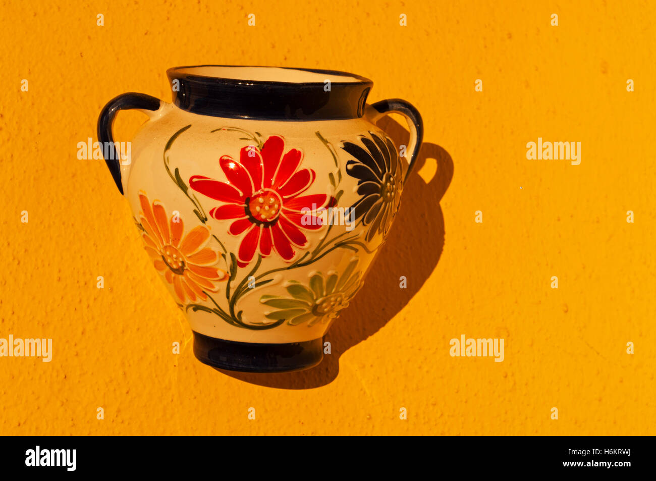 Typical Andalucian wall-mounted flowerpot. Stock Photo