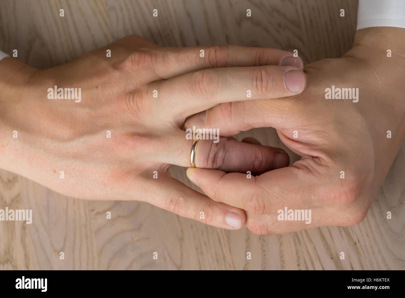 Divorce, separation hands of man removing wedding or engagement ring