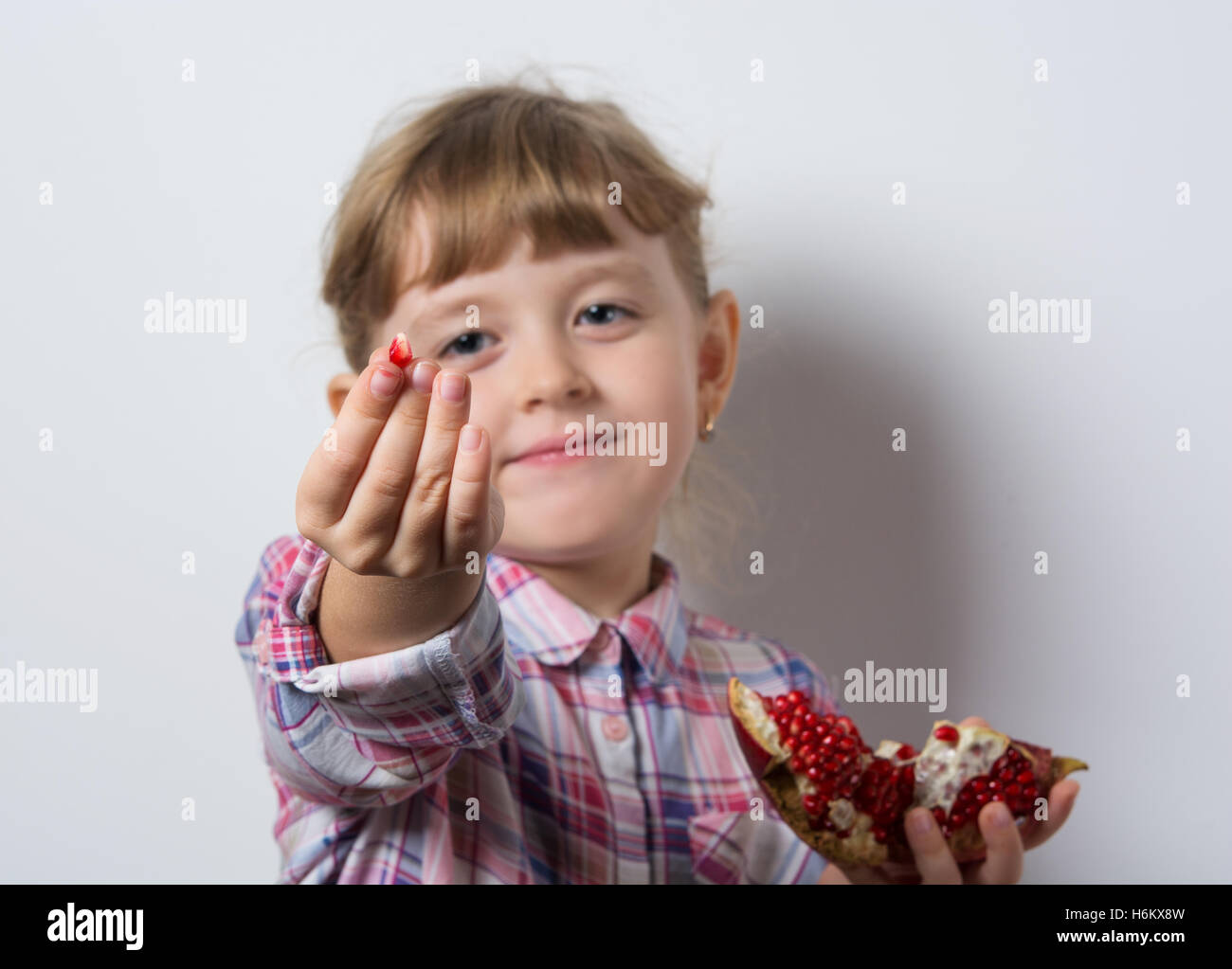 girl eats juicy pomegranate Stock Photo