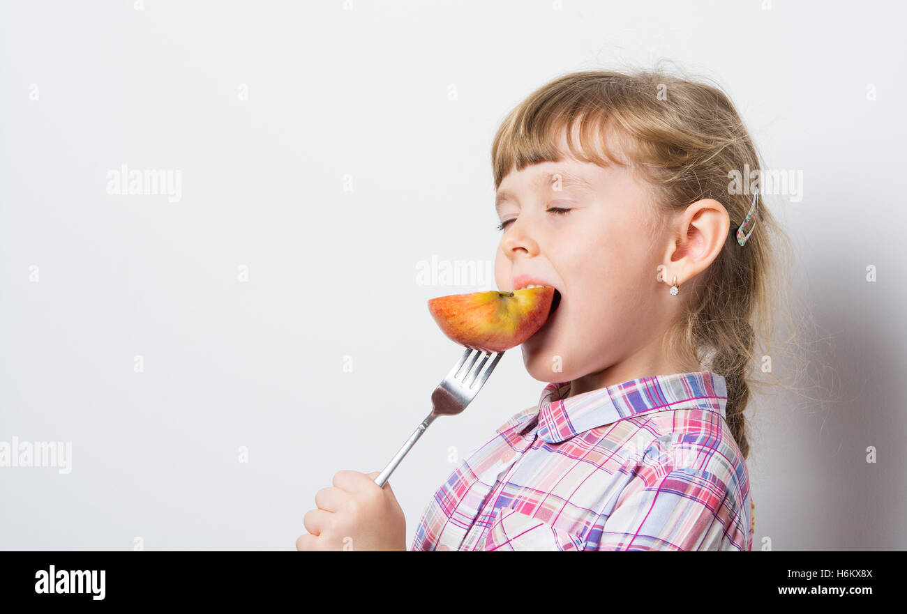 girl eats ripe Apple Stock Photo