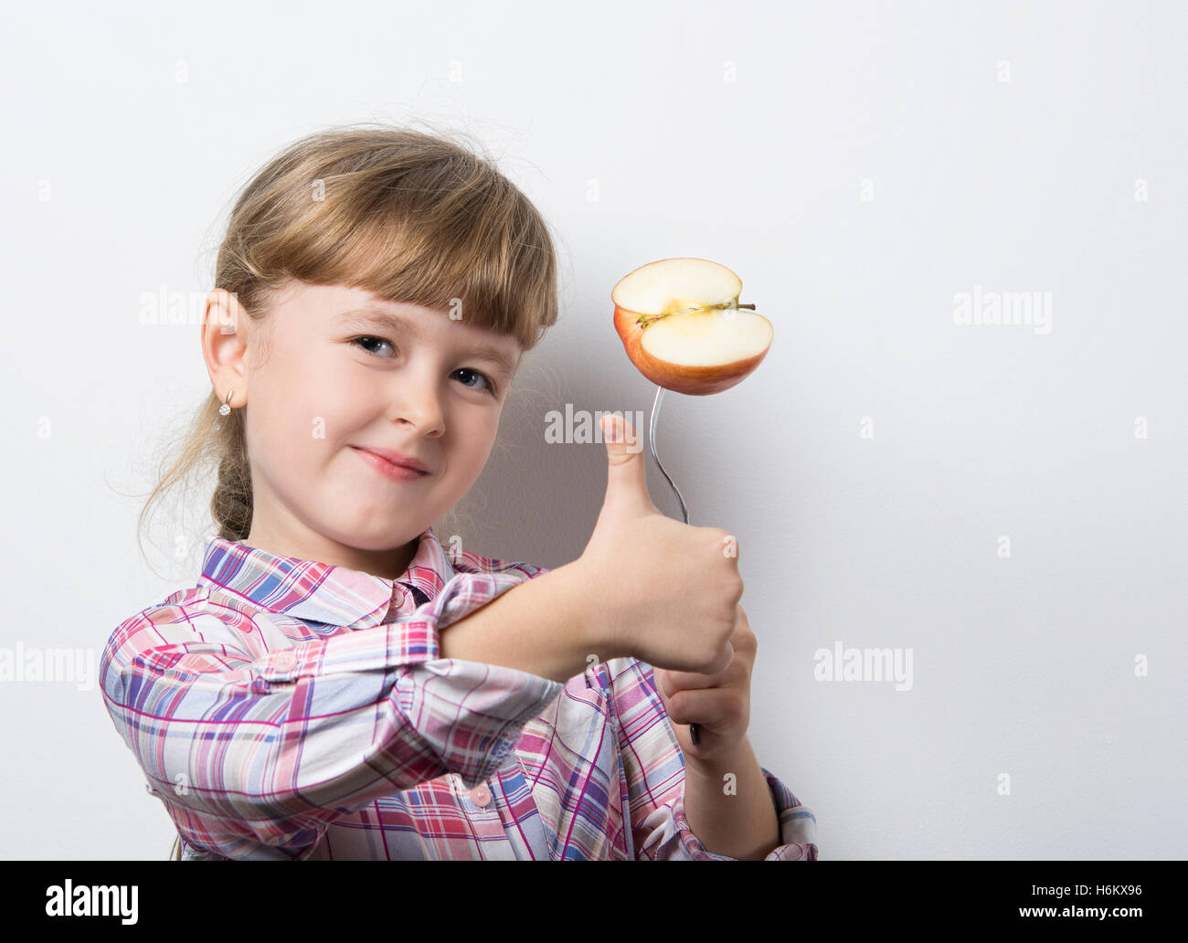 little girl eats ripe Apple Stock Photo