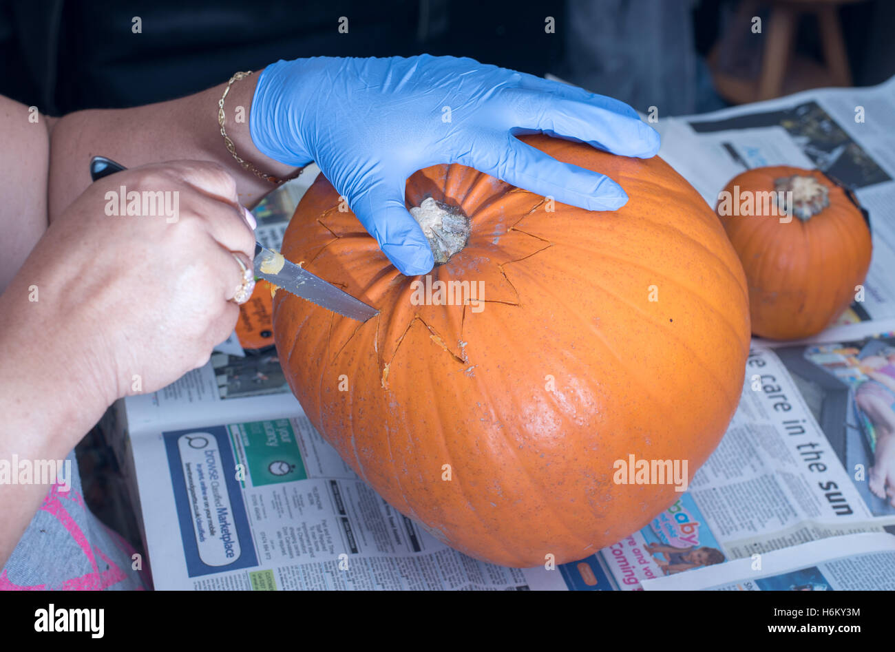 Pumpkin carving - opening it up Stock Photo
