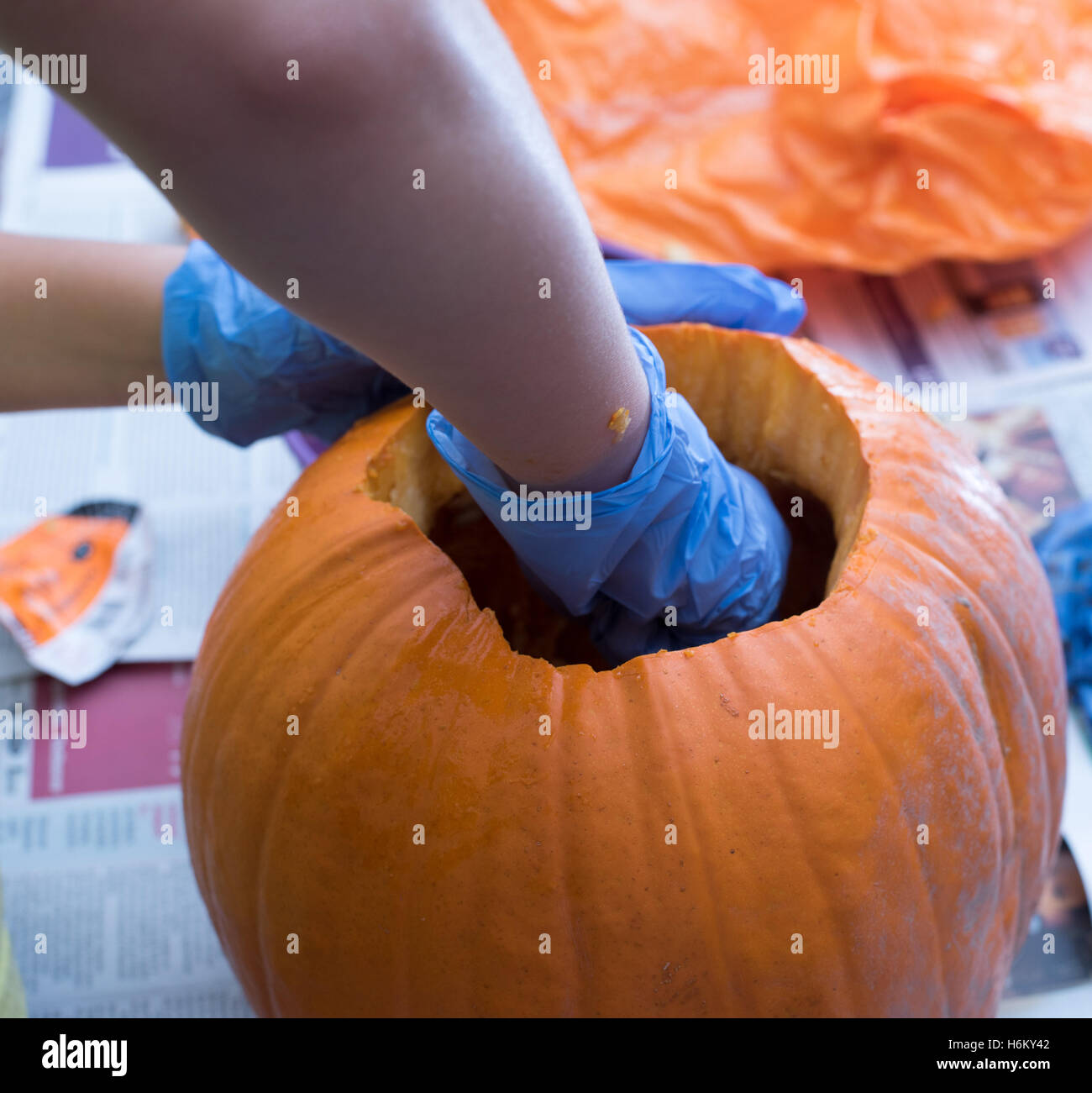 Pumpkin caring, scooping out Stock Photo