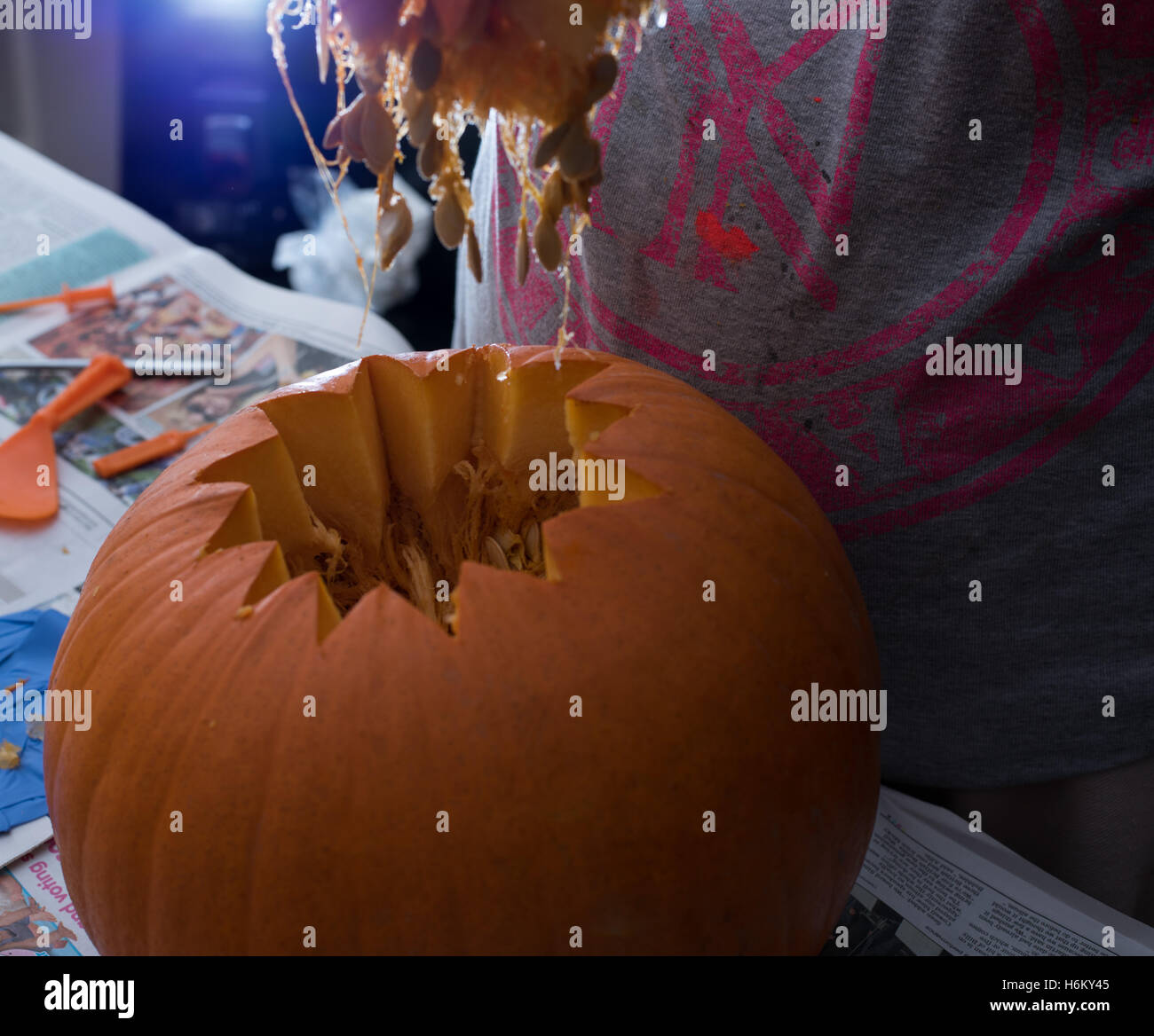 Pumpkin carving, scooping out Stock Photo