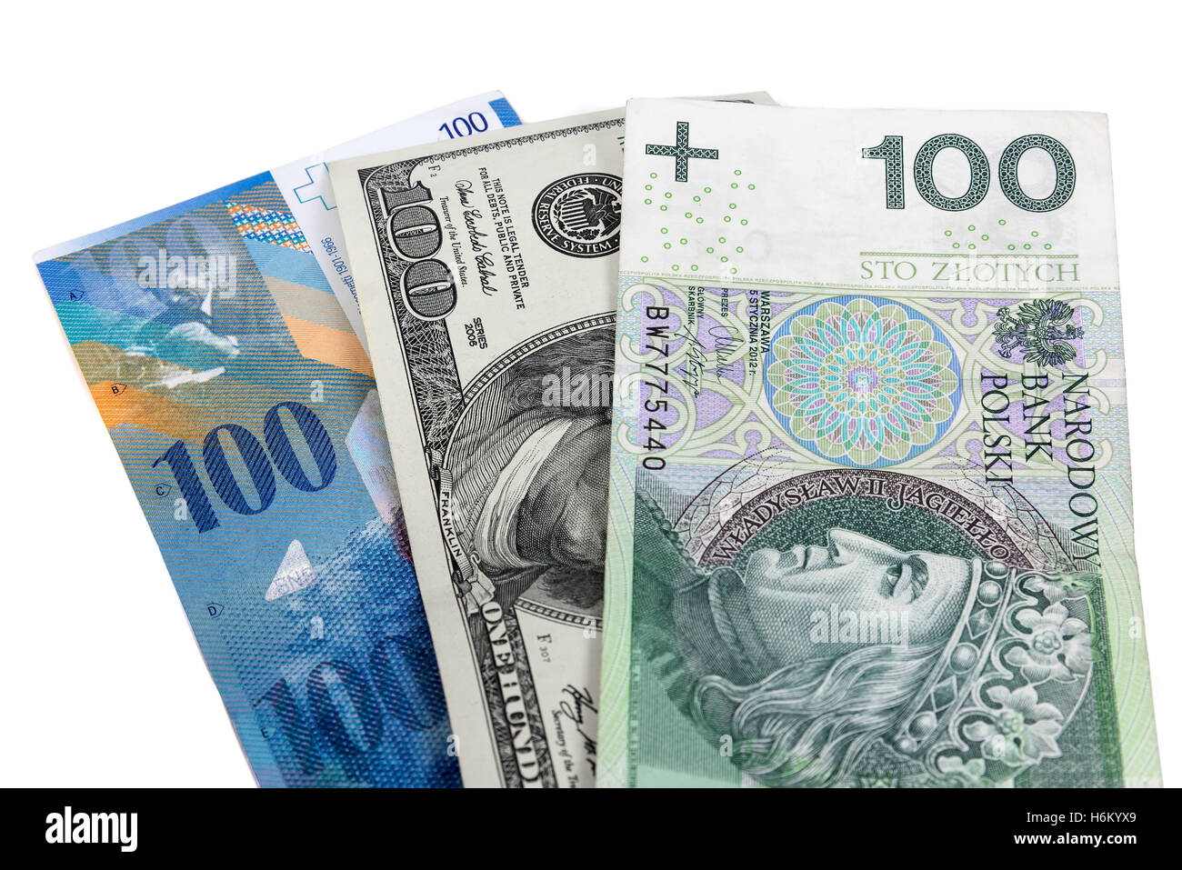 Banknotes of 100 dollars, polish zloty and swiss franc isolated on white background with clipping path Stock Photo