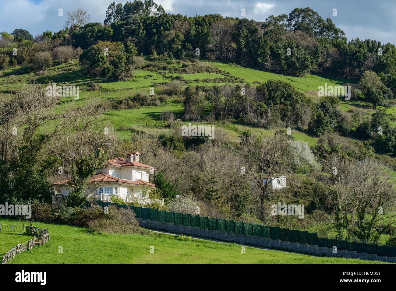 Solitude alone house nestled on the side of a hill in the village of Laredo, Cantabria, Spain Stock Photo