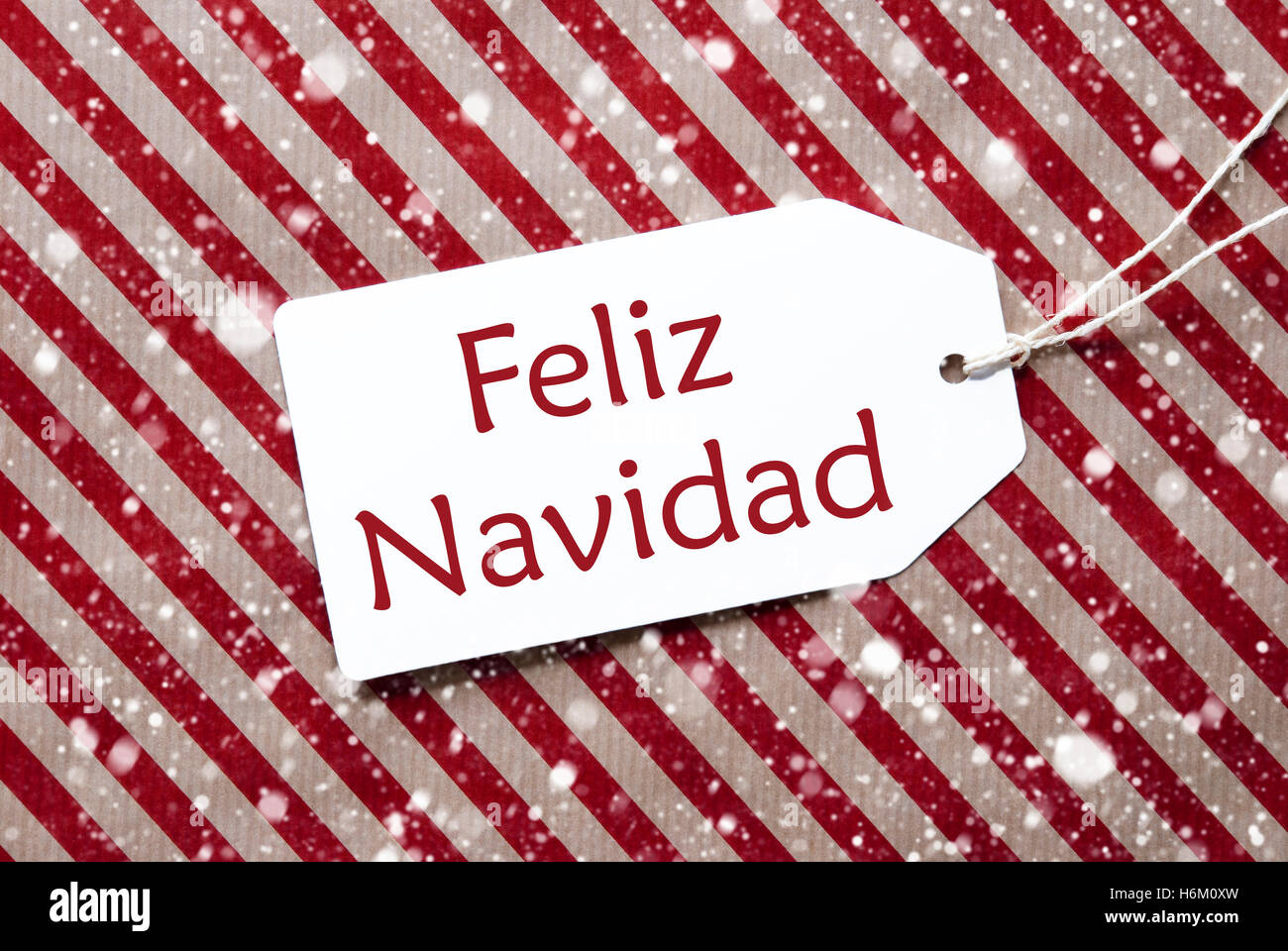 Label On Red Paper, Feliz Navidad Means Merry Christmas, Snowflakes Stock Photo