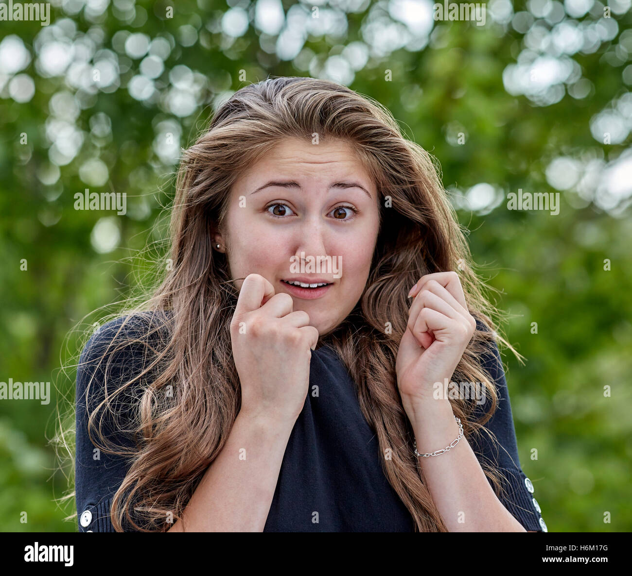 Scared and Frightened young woman with long hair Stock Photo