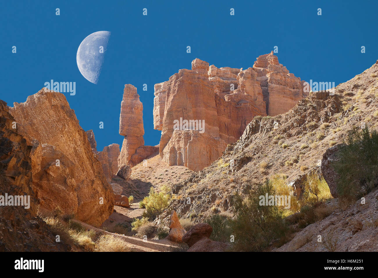 Majestic cliffs on a background of blue sky with a moon. Charyn canyon, Kazakhstan. Stock Photo