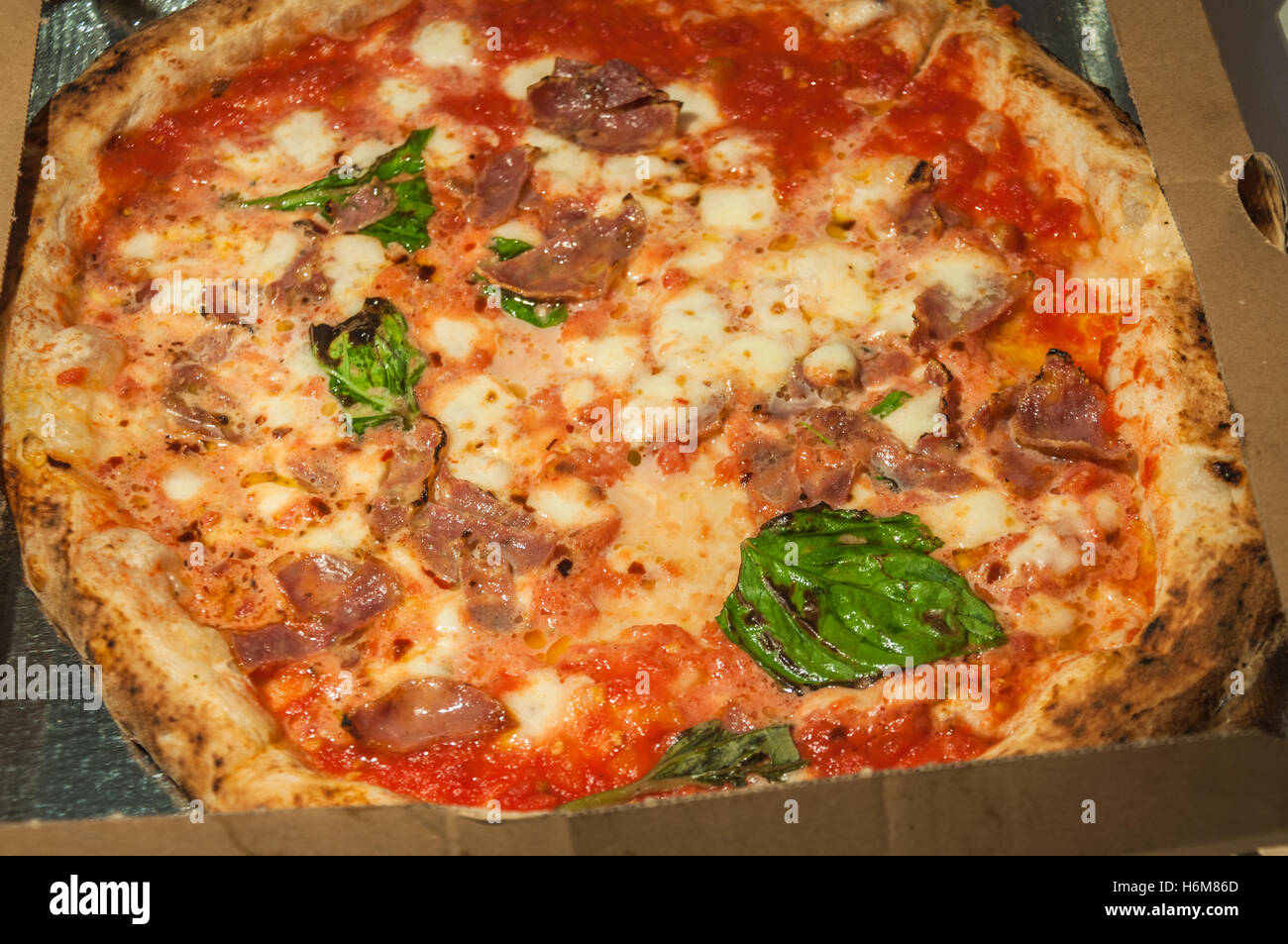 The classic Neapolitan pizza in a take-away box. Stock Photo