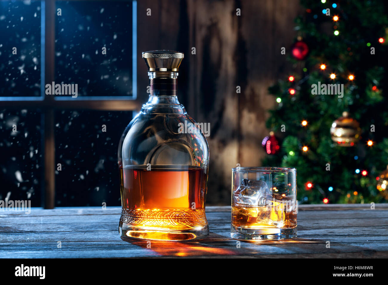 close up view  of glass  with whiskey and bottle  on color back Stock Photo