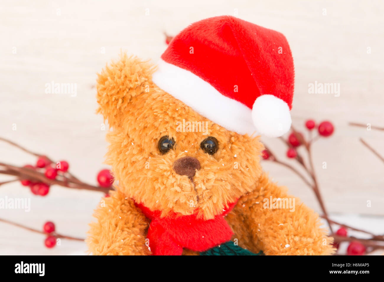 Cute teddy bear with red hat. Christmas atmosphere Stock Photo - Alamy
