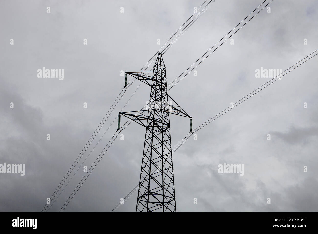 High-voltage tower on a grey sky of background Stock Photo - Alamy