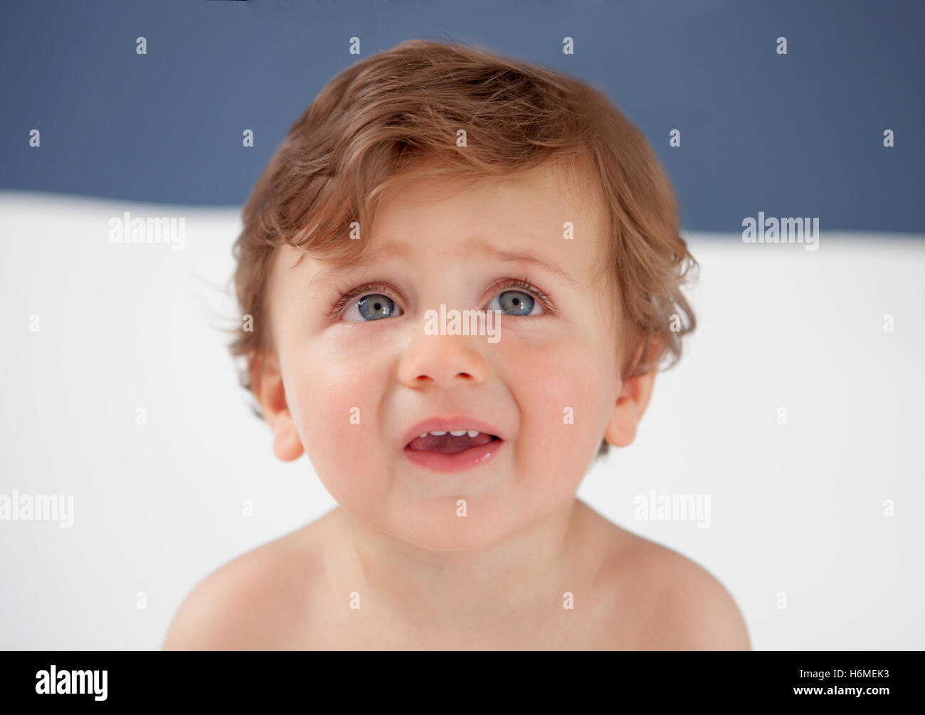 Baby with one years old with blue eyes looking up Stock Photo Alamy