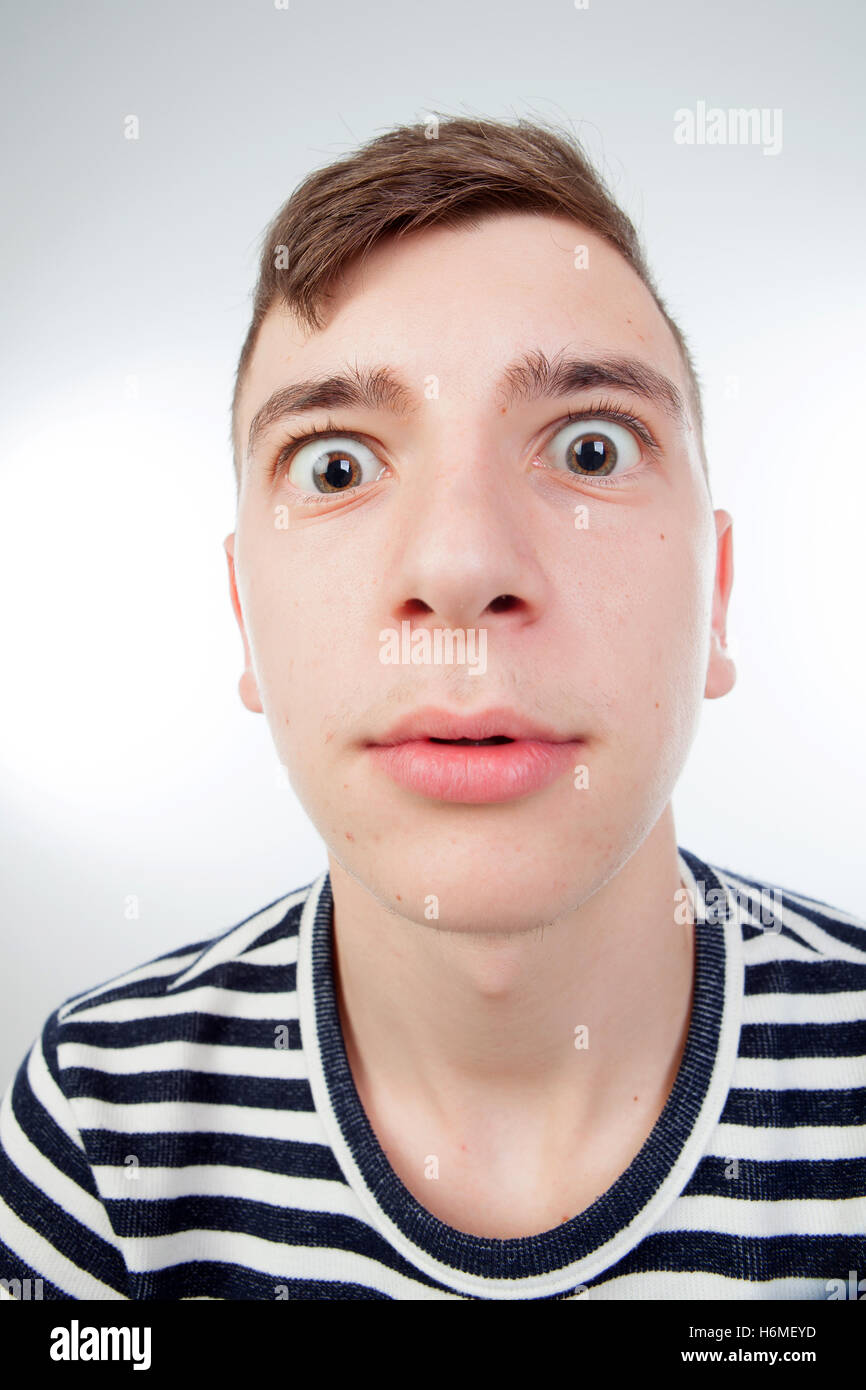 Funny guy grimacing with her face isolated on white background Stock Photo