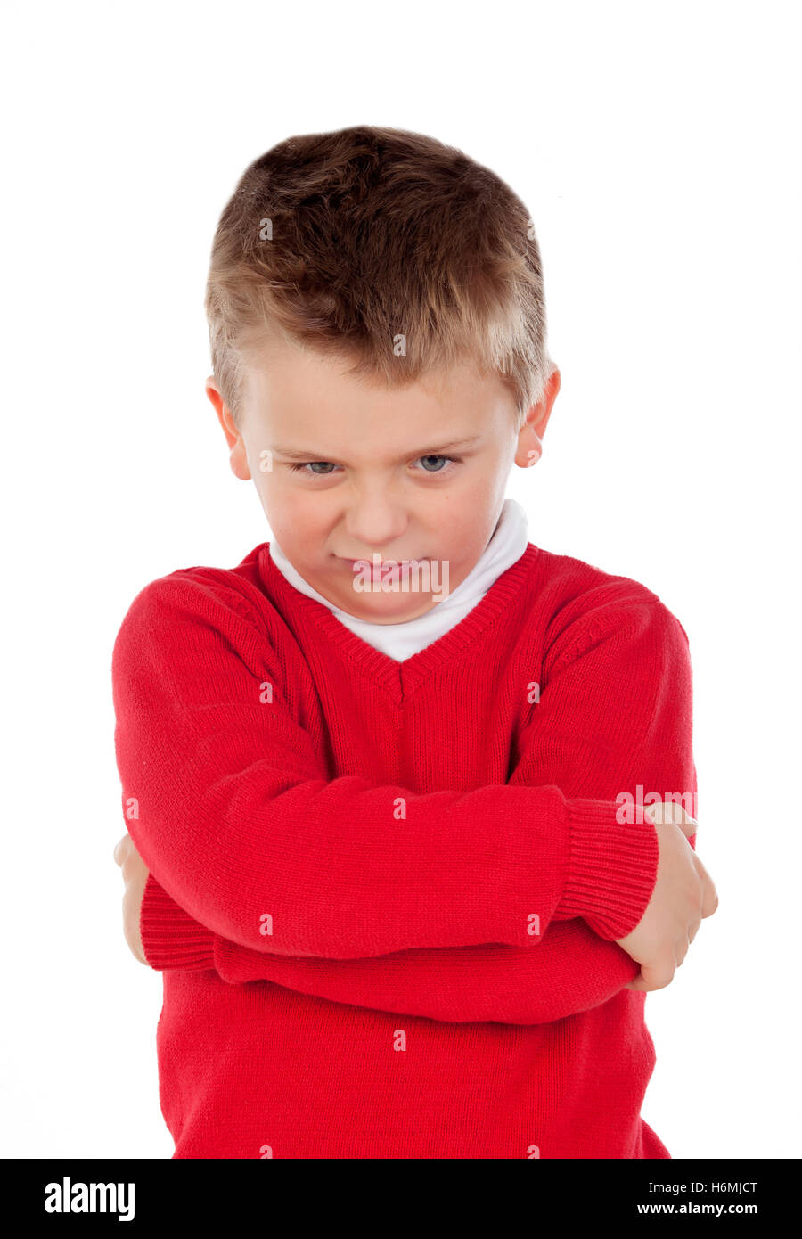 Little angry kid with red jersey isolated on a white background Stock Photo