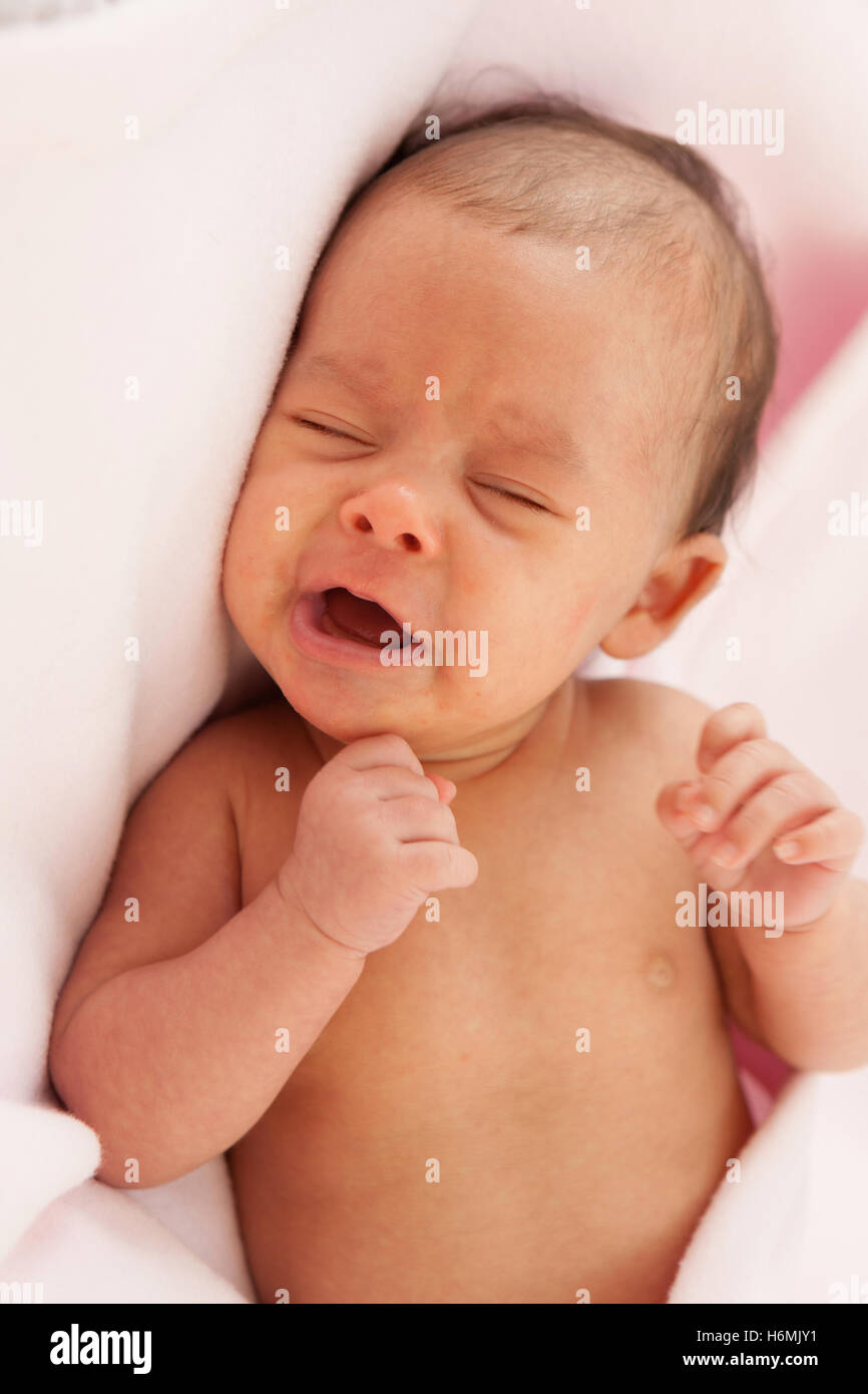 Beautiful baby wrapped in a pink blanket Stock Photo - Alamy