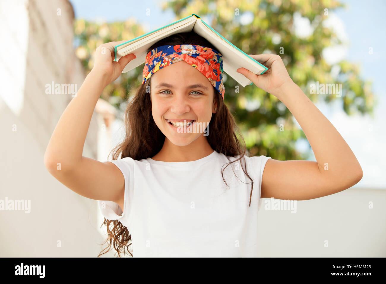 Pretty Twelve Year Old Student with a book outdoor Stock Photo Alamy