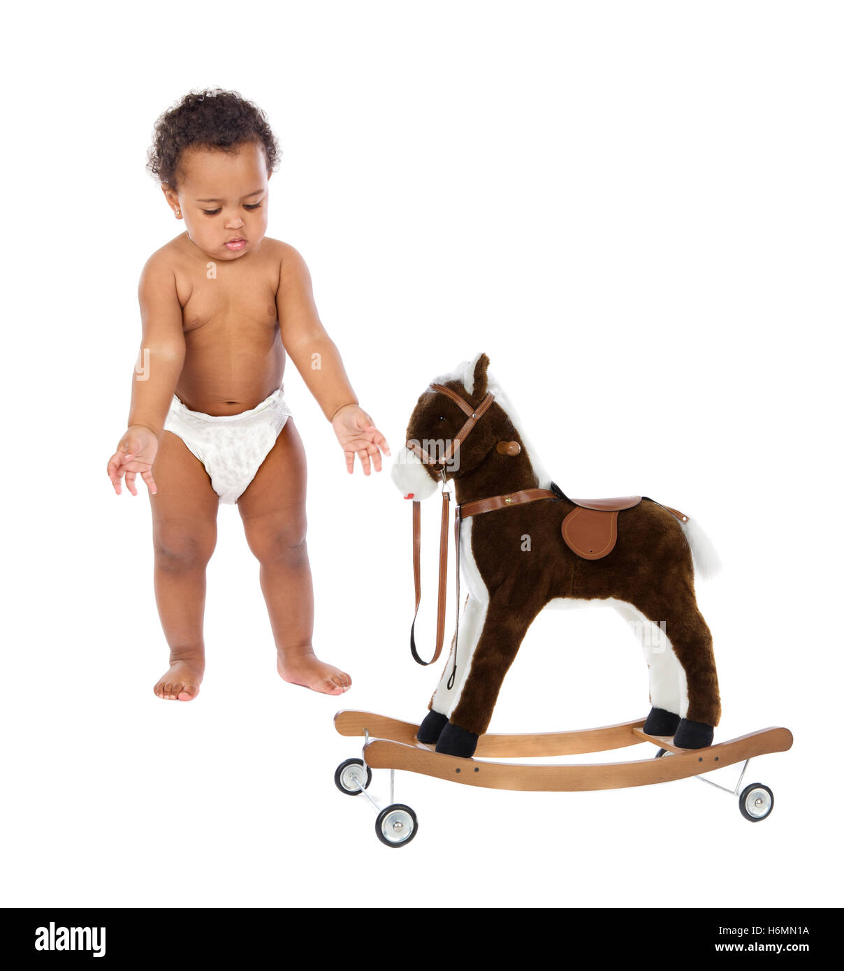 Funny african baby in diaper with a wooden horse isolated on a white