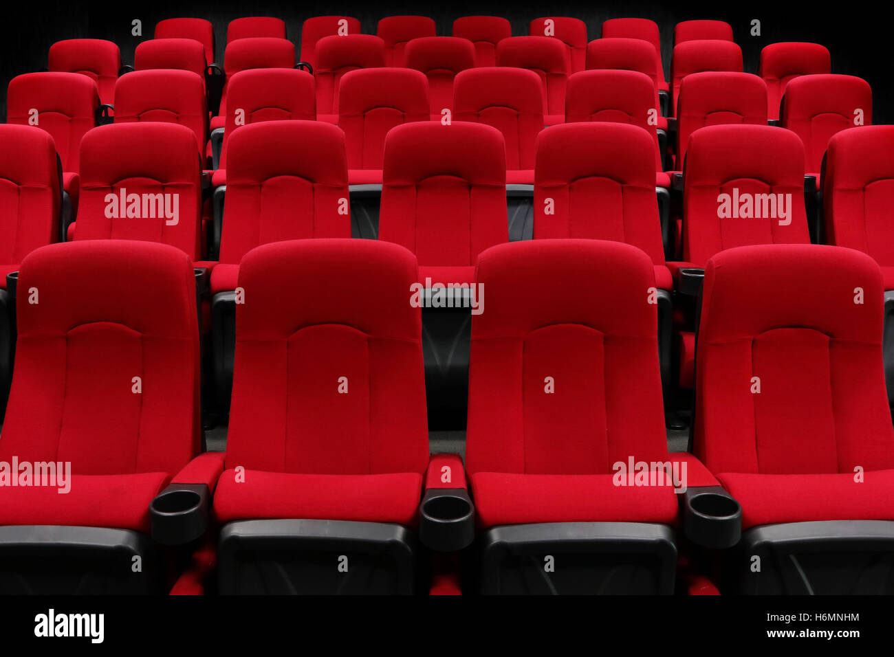 Empty theater auditorium or cinema with red seats Stock Photo