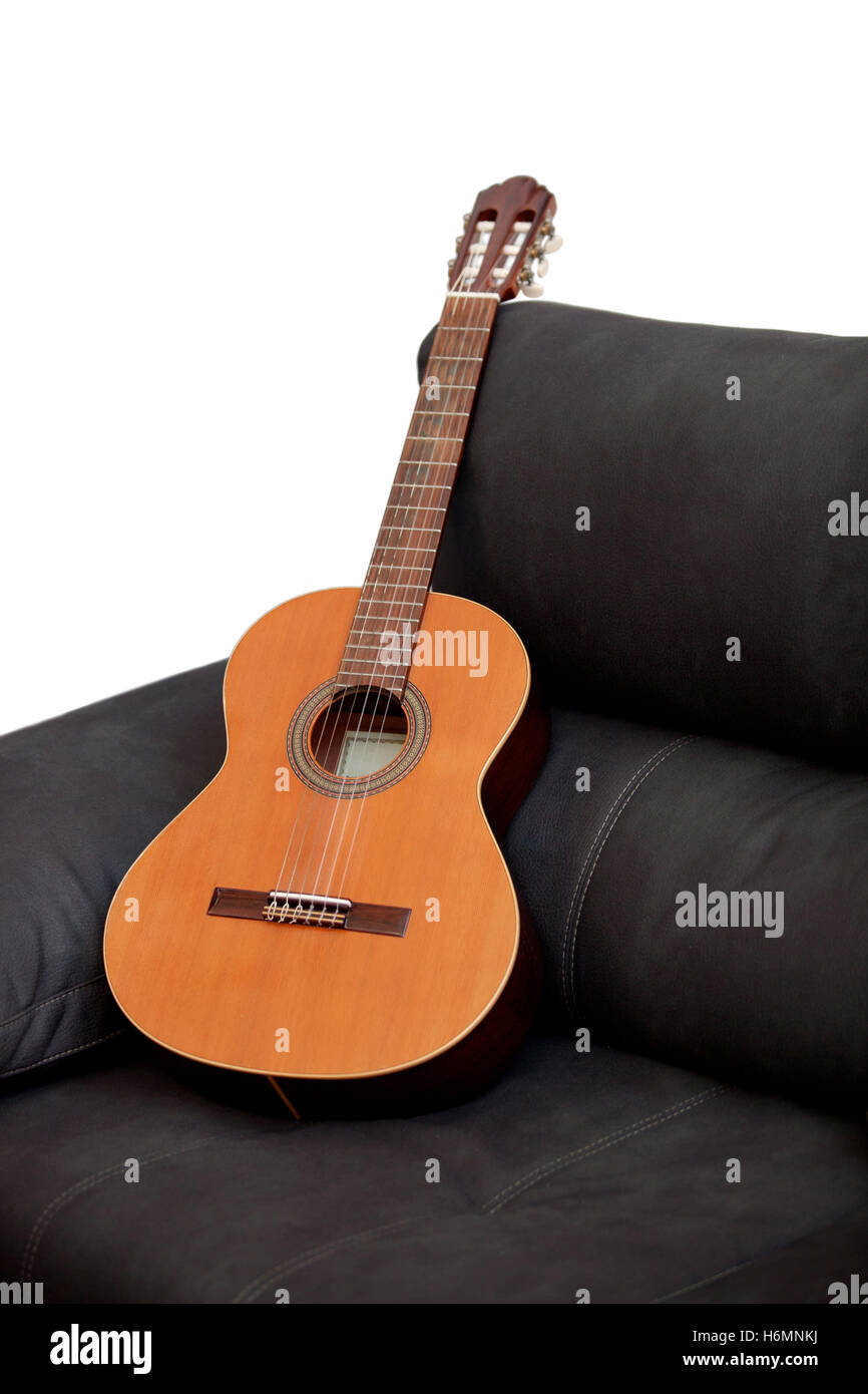 Wooden classical guitar on the grey sofa Stock Photo Alamy