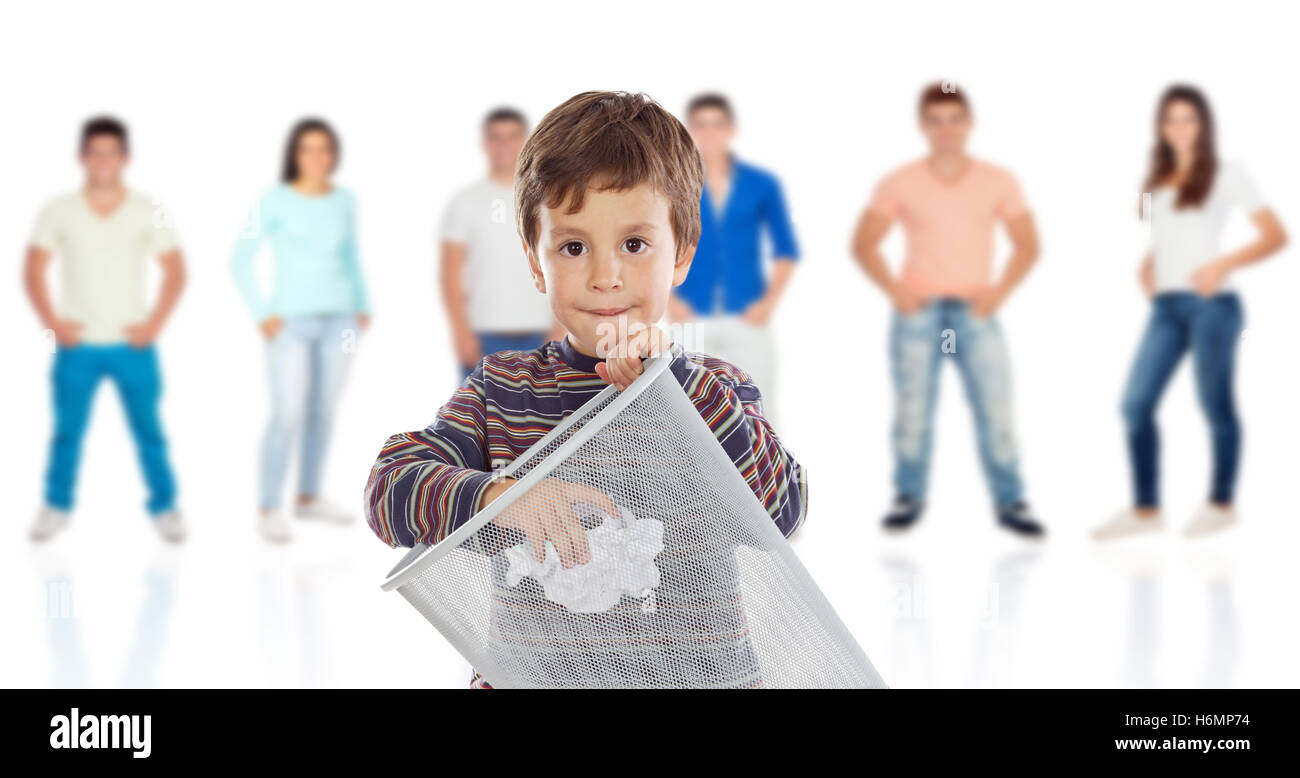 Funny kid throwing a role in the bin with young people of background unfocused Stock Photo