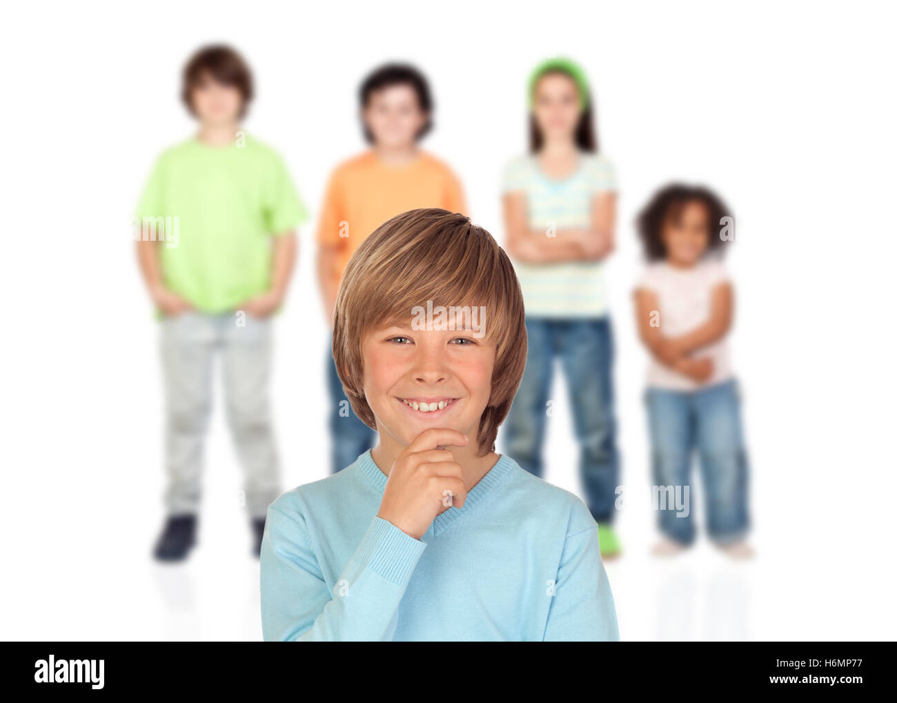Doubtfully teenager boy with other children of bakcgrund unfocused Stock Photo