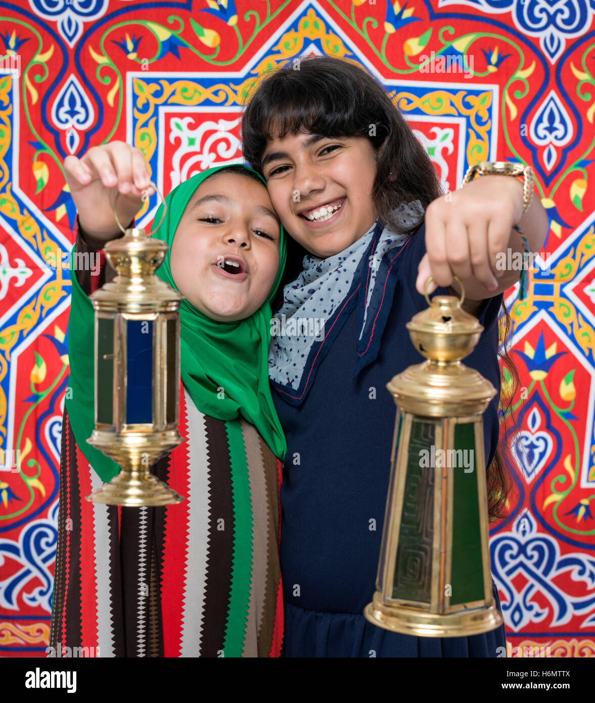 Two Happy Friends Celebrating Ramadan Over Ramadan Traditional Background Stock Photo