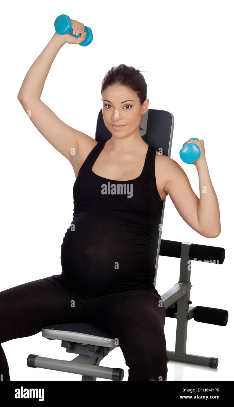 Pregnant woman lifting weights isolated on a white background Stock
