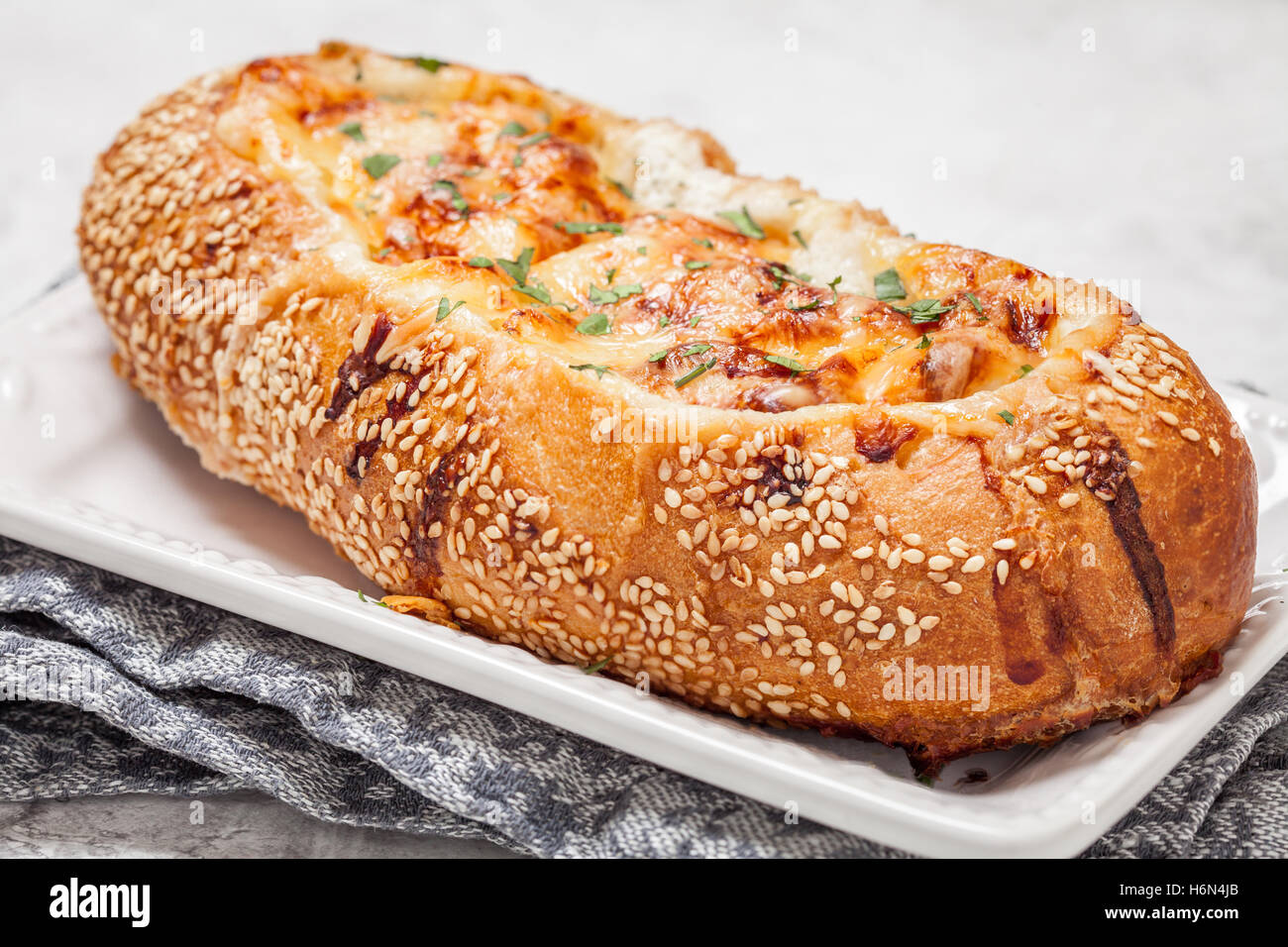 Baked fish casserole in a bread bowl Stock Photo