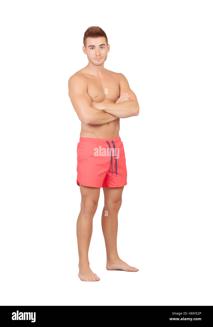 Handsome lifeguard with red swimsuit isolated on white background Stock Photo