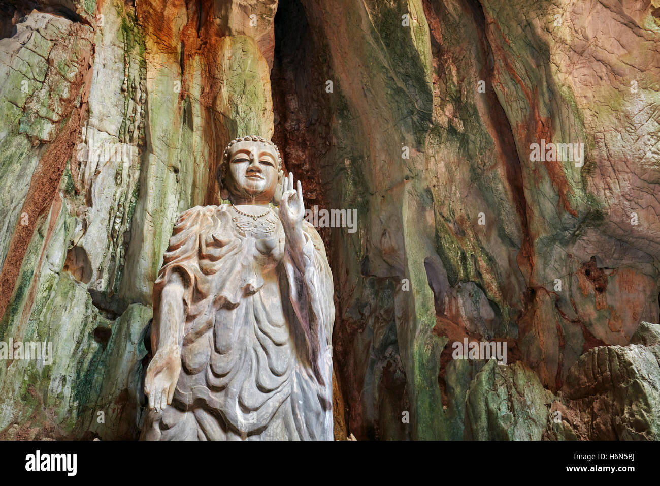 The Upright Buddha statue in Tang Chon Cave. Thuy Son Mountain, The Marble Mountains, Da Nang, Vietnam. Stock Photo