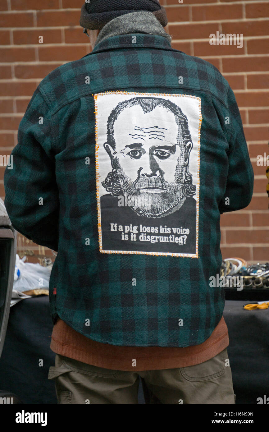 A Vendor In Soho New York City Wearing A Shirt With A Funny George Carlin Portrait And Wordplay Joke Stock Photo Alamy